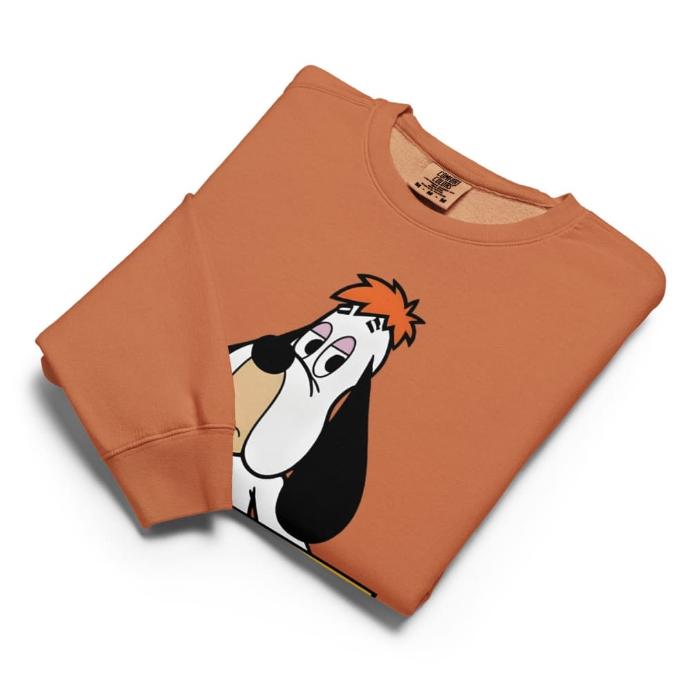 Folded orange sweatshirt with cartoon character on a white background